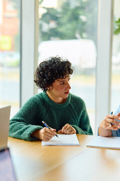 Young woman study with her classmate indoors