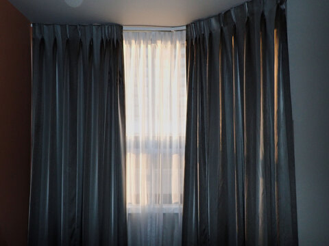 Sunlight Filtering Through Sheer Curtains in Quiet Interior