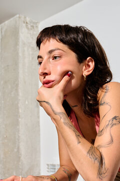 Thoughtful Business Woman with tattoos