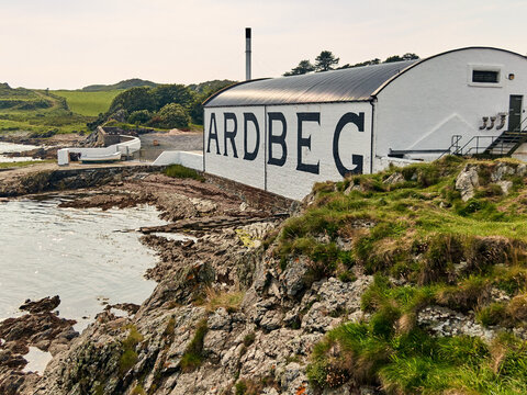 Ardbeg distillery on the rugged coast of Islay, traditional scotch whisky production heritage and coastal landscape in Scotland, United Kingdom