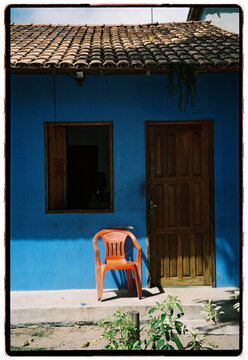 Blue Facade With Orange Chair