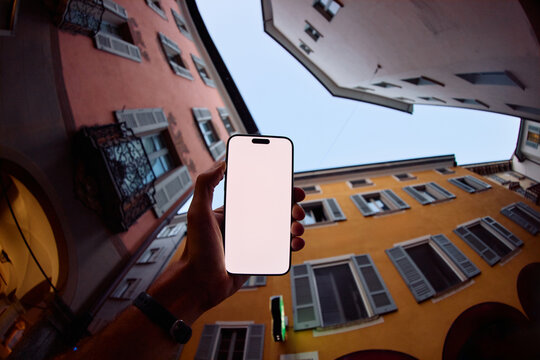 Person Holds a phone In Alley