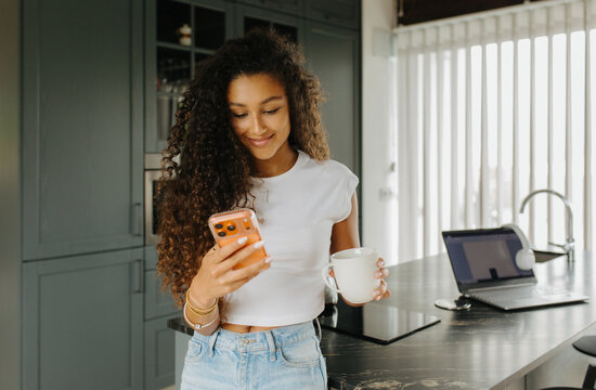 Woman Smiling Holding Coffee Near Sink