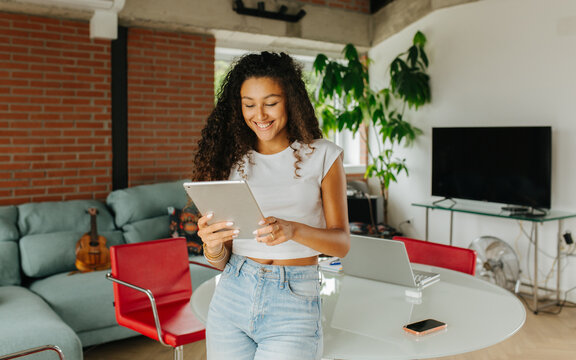 Woman Smiling Holding Digital Tablet