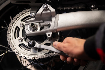 Mechanic Repairing Motorcycle With Wrench in Close Up © Lukas Gojda