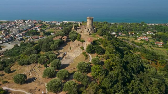 Torre di Velia Cilento Italy 4K drone video. Flyover ancient tower with small amphitheater and archeological ruins over sea background. Travel b roll stock footage