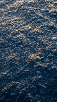 Direct overhead angle showing crystal clear aqua water waves with bright highlights