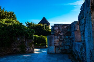 Stone walls and tower against a bright blue sky © Novanture