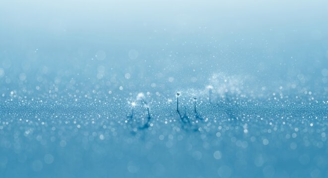 Abstract blue background with shimmering light and subtle textures, creating a serene and ethereal visual experience.