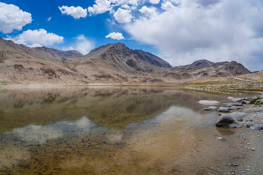 High altitude mountain landscape view of colorful lake and reflection between Khargush pass and Pamir Highway, Murghab, Gorno-Badakhshan, Tajikistan