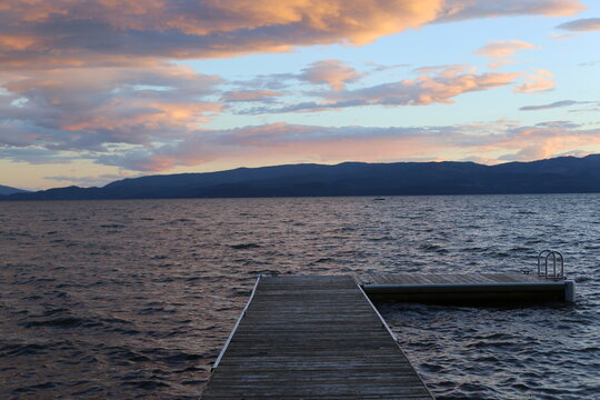 Photo of sunset over a lake dock in Flathead Lake, Montana