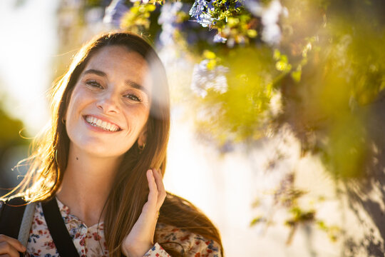 Radiant brunette woman smiling in golden sunlight