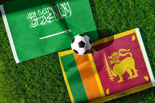 Saudi Arabia vs. Sri Lanka football match. National flags on green grass with soccer ball in the middle. Football background for international match.
