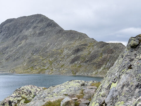 Steep slope above the blue lake Bessvatnet, Jotunheimen, Norway