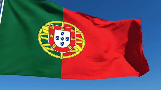 The national flag of portugal waving against a clear blue sky