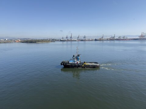 tug boat proceeding at harbor area.