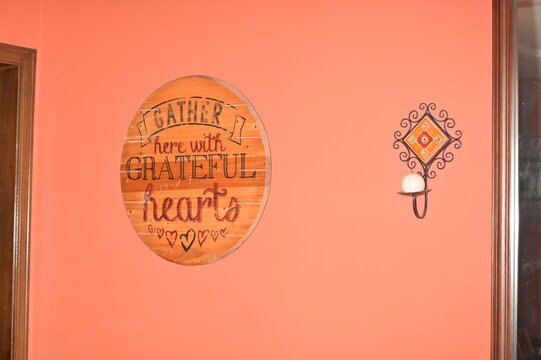 Wooden Sign and Candle Holder on a Wall in a House