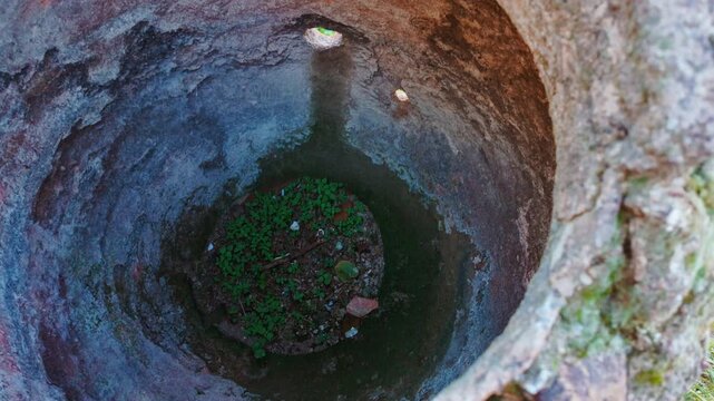High-angle view looking inside a large ancient terracotta pithos storage jar and the Holy Church of the Holy Apostles of Solakis, Athens, Greece
