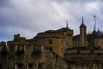Historic stone castle with towers against a cloudy sky © Novanture