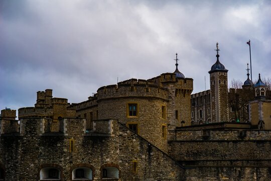 Historic stone castle with towers against a cloudy sky