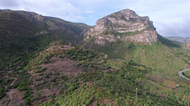 Stunning aerial footage showing the majestic Monte Lora mountain. Drone view of the lush green vegetation covering the Sardinian landscape
