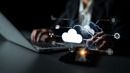 Plakat Modern Business Professional Working on Laptop with Cloud Technology Graphics and Digital Connectivity Concept in Dark Office Environment. Bitwise.