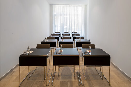 Modern conference room table setup with water bottles and glasses