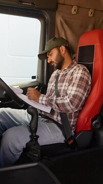 Truck driver filling out paperwork in right hand drive car