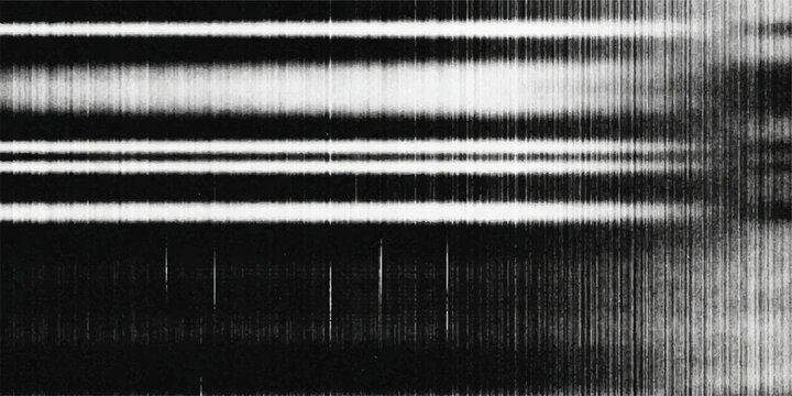 A scientific spectrogram displays sharp, luminous spectral lines against a dark background, representing the analysis of light or electromagnetic radiation.