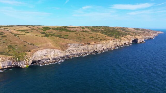 Aerial shot flying towards and over the cliffs of the Jurassic coast near Dancing Ledge, Dorset, UK