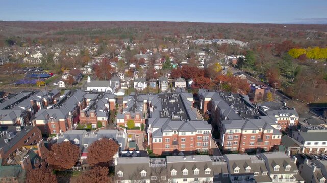 Aerial view of suburban town with autumn foliage and residential buildings