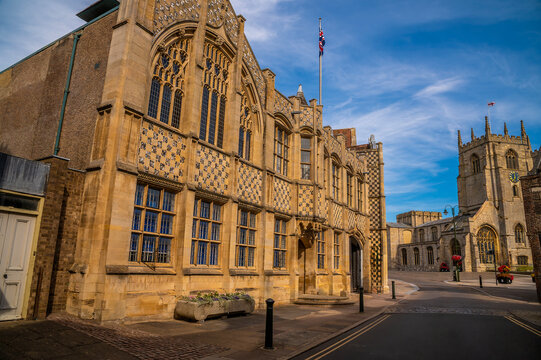 A view of the historic King's Lynn Town Hall on the Saturday Market Place with King's Lynn Minster seen in the background in summertime