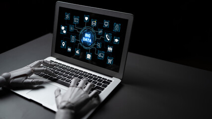 Futuristic robot hand interacting with laptop displaying big data concept, digital icons and data...