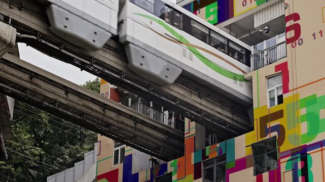 train enters liziba station inside a building on bridge in Chongqing china