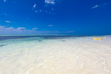Tropical sandy beach and an exotic view of the Atlantic Ocean against a blue sky with clouds in Cuba, Caribbean – background for projects, wallpaper © anettastar