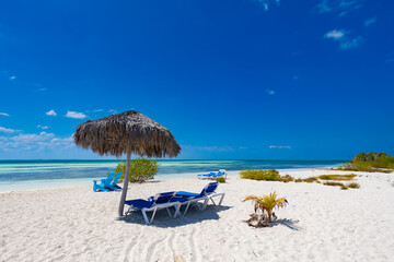 Tropical sandy beach and an exotic view of the Atlantic Ocean against a blue sky with clouds in Cuba, Caribbean – background for projects, wallpaper © anettastar