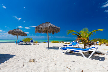 Tropical sandy beach and an exotic view of the Atlantic Ocean against a blue sky with clouds in Cuba, Caribbean – background for projects, wallpaper © anettastar