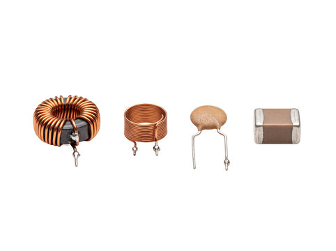 Electronic components copper inductor coil capacitor set isolated on black background for circuit board hardware design, engineering microelectronics detail, radio frequency, electrical engineering.