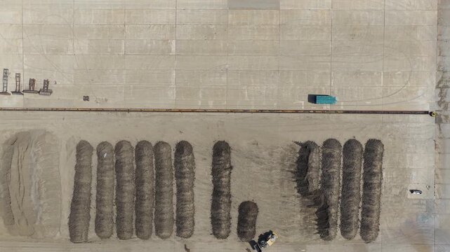 Aerial View of Sugar Beets Piled in Rows at a Sugar Refinery During a Bright Sunny Afternoon Day