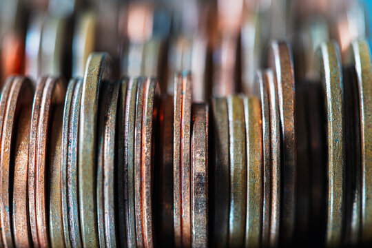 Rows of small cent coins covered with patina. Surface degradation and material aging in non-ferrous metals