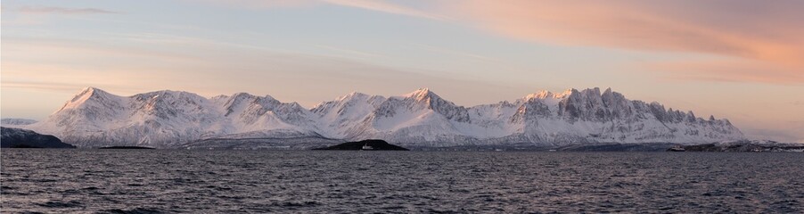 Norway fjords landscape with snow-capped mountains at sunset © Kristof