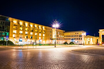 Illuminated buildings and street at night © Novanture