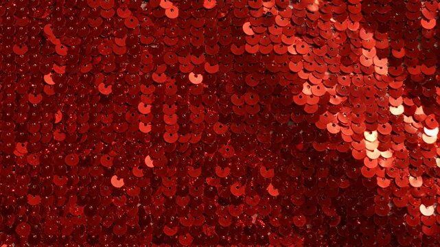 Close up of red shimmering sequin fabric texture
