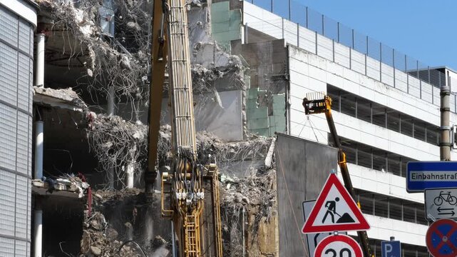 Heavy Excavator Boom at Urban Building Demolition Site | Construction Work, Concrete Rubble and Road Signs