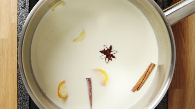 Cook places saucepan with milk mixture on stove. Spanish custard uses citrus peel, cinnamon and vanilla. Crema catalana cooks until smooth before chilling in ramekins and caramelizing sugar.
