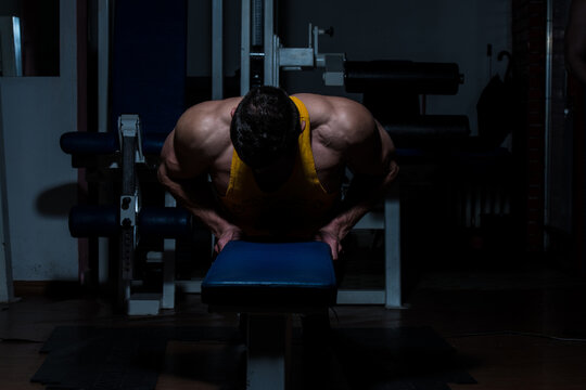 young man doing push ups in gym