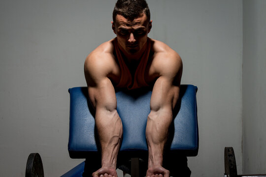 fitness trainer doing heavy weight exercise for biceps