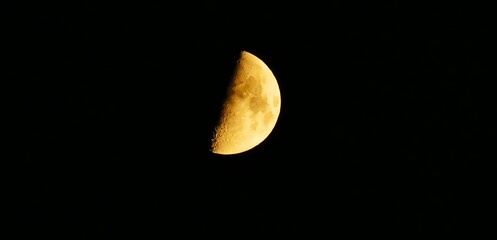 Moon surface phase with craters shine bright on the dark background, astronomy space sphere background © moreidea