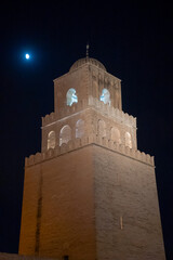 Obraz premium Moon behind the minaret on the Great Mosque of Kairouan in the medina, in Kairouan, Tunisia, at night