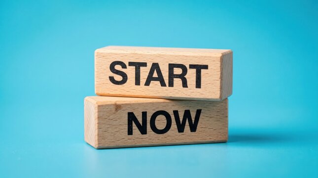 Wooden blocks with the words START and NOW stacked on top of each other against a bright blue background